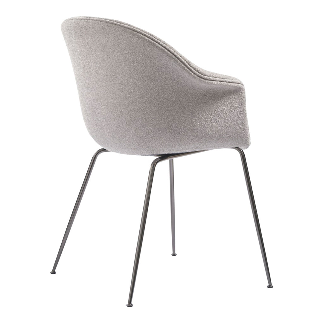 Gray upholstered chair with smooth texture and black slender legs, showcasing a minimalist design.