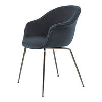 Modern dark blue upholstered chair with curved silhouette and sleek black metal legs, perfect for contemporary decor.