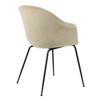 Beige upholstered chair with smooth curves, paired with sleek black metal legs for a modern touch.
