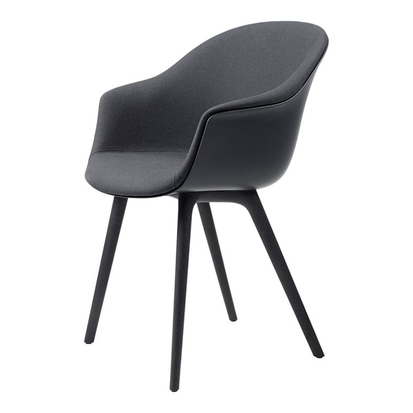 Modern black armchair with a sleek, textured fabric and minimalist design, complemented by sturdy black legs.
