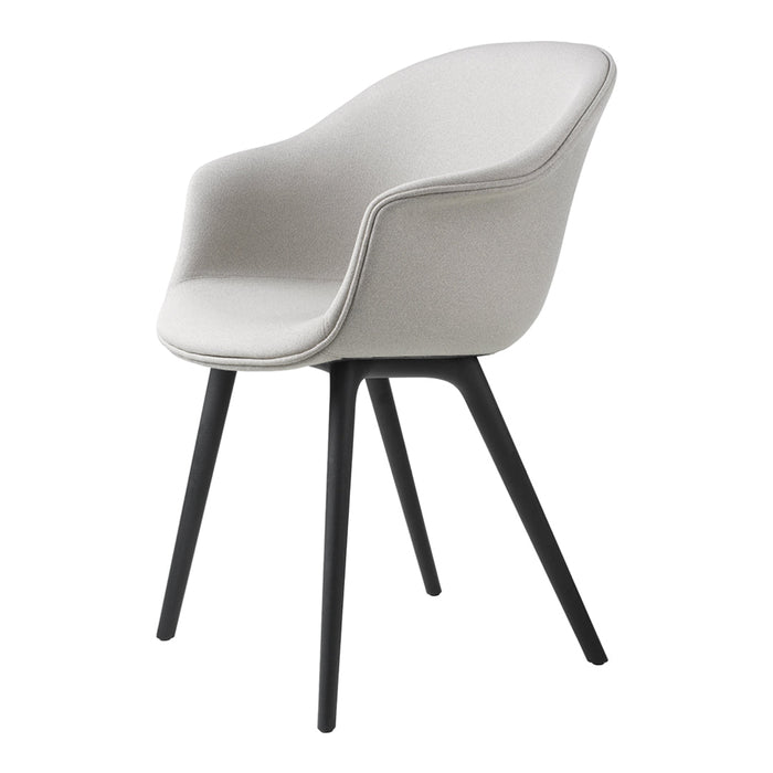 Light gray upholstered chair with smooth, curved design and black tapering legs. Modern, minimalist aesthetic.