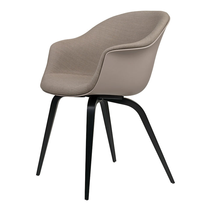 Tan upholstered chair with smooth curves and sleek black legs. Elegant and modern design.