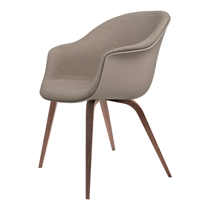 Light beige modern chair with curved design, soft texture, and contrasting dark wooden legs.