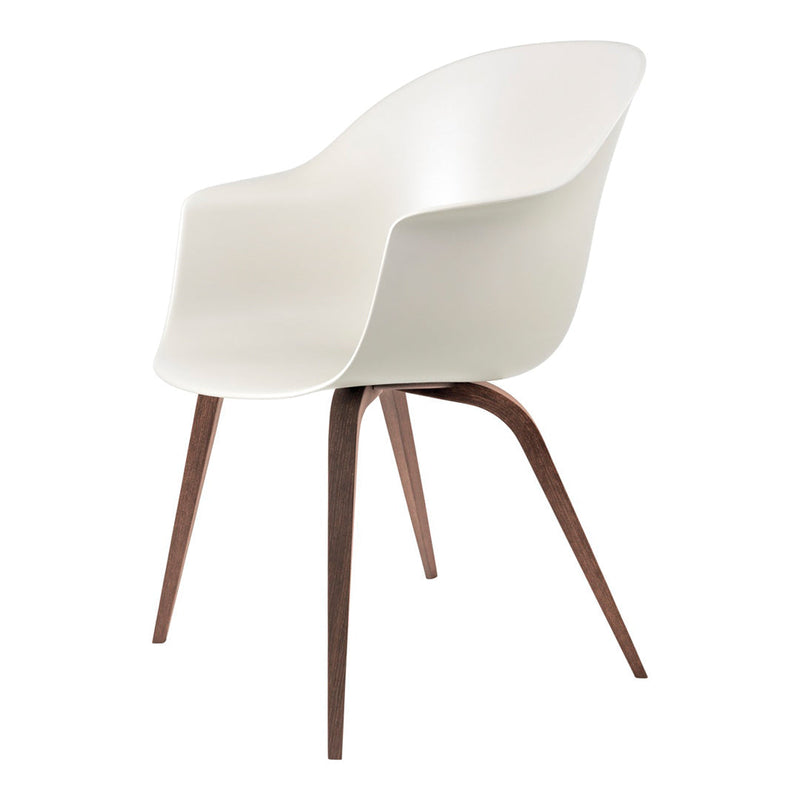 White molded chair with smooth finish and contrasting dark wood legs. Minimalist design perfect for modern decor.