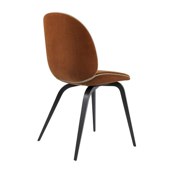 Brown upholstered chair with a sleek black metal base, featuring a minimalist design. Ideal for modern decor.