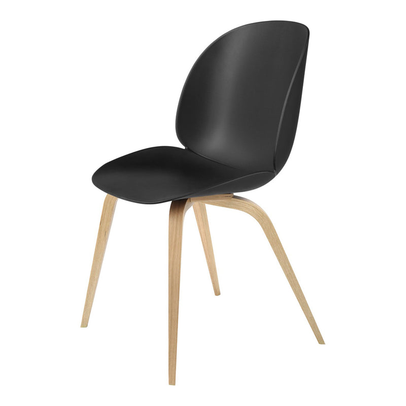 Black molded chair with natural wooden legs, featuring a sleek, minimalist design and smooth finish.