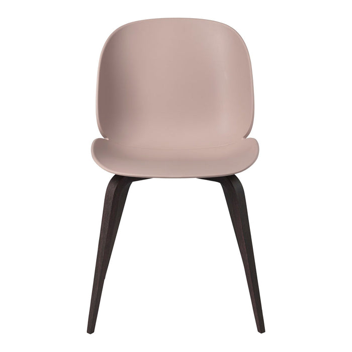 Soft pink chair with smooth curves and dark wood legs, featuring a minimalistic design. Perfect for modern decor.