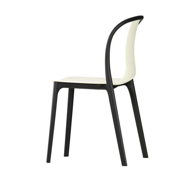 Black and white modern chair with a sleek, minimalist design. Smooth surfaces and curved backrest accentuate elegance.
