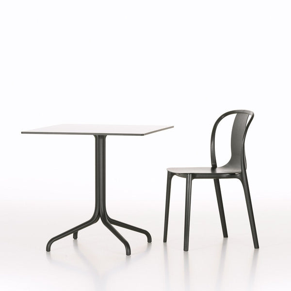 Modern black table and chair set against a minimalistic white background, showcasing sleek lines and contemporary design.