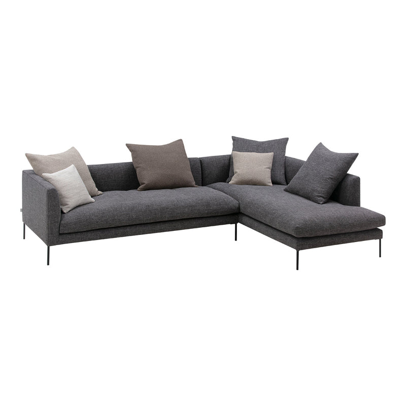 Gray sectional sofa with a textured fabric and decorative neutral throw pillows in various shades. Modern, minimalist design.