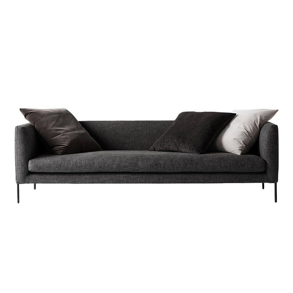Stylish gray sofa with dark and light accent pillows, featuring a minimalist modern design. Perfect for contemporary decor.