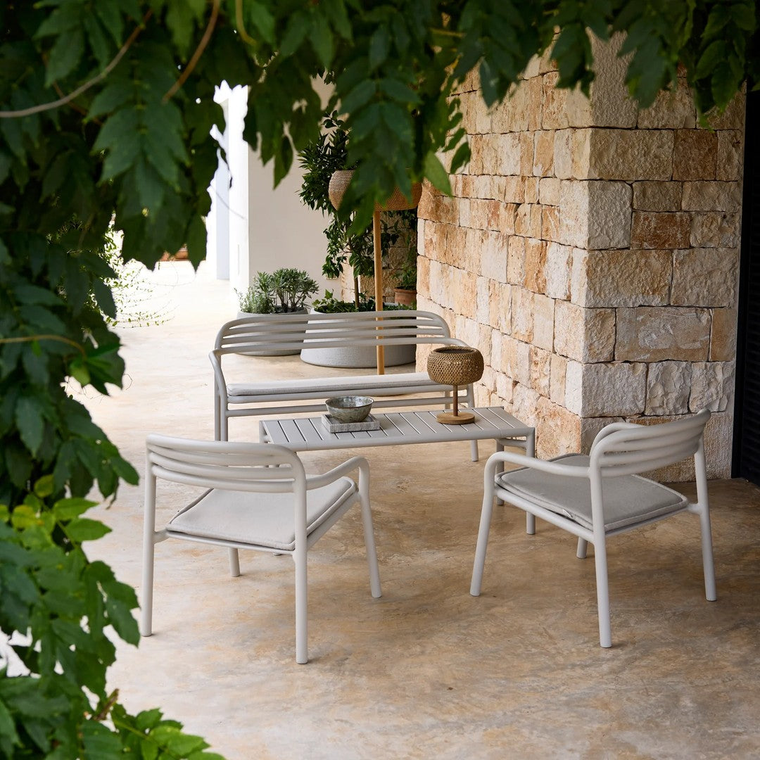 Stylish outdoor seating set in neutral beige tones, featuring sleek lines and a simple, modern design.