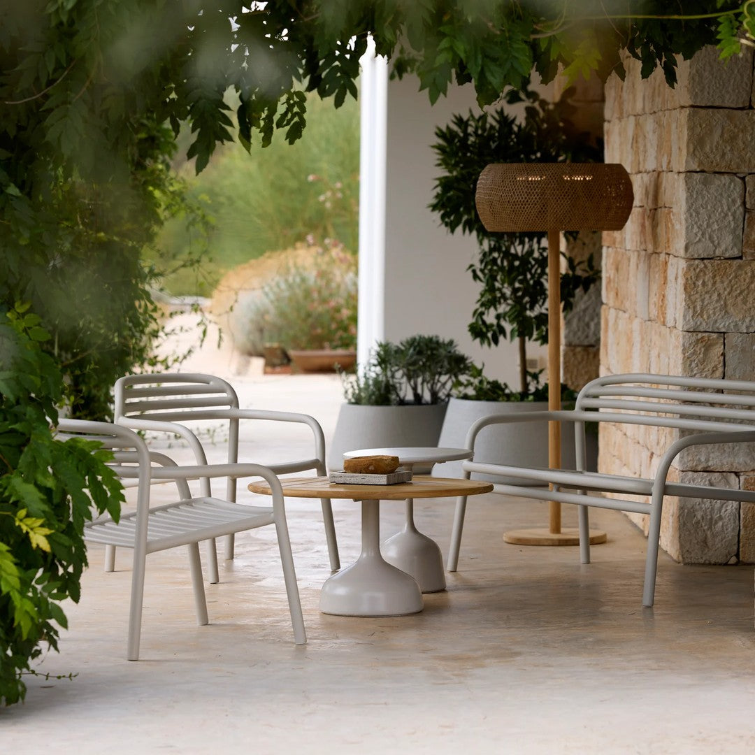 "Modern outdoor seating in soft grey with natural wood accents, featuring a minimalistic design and stylish textures."