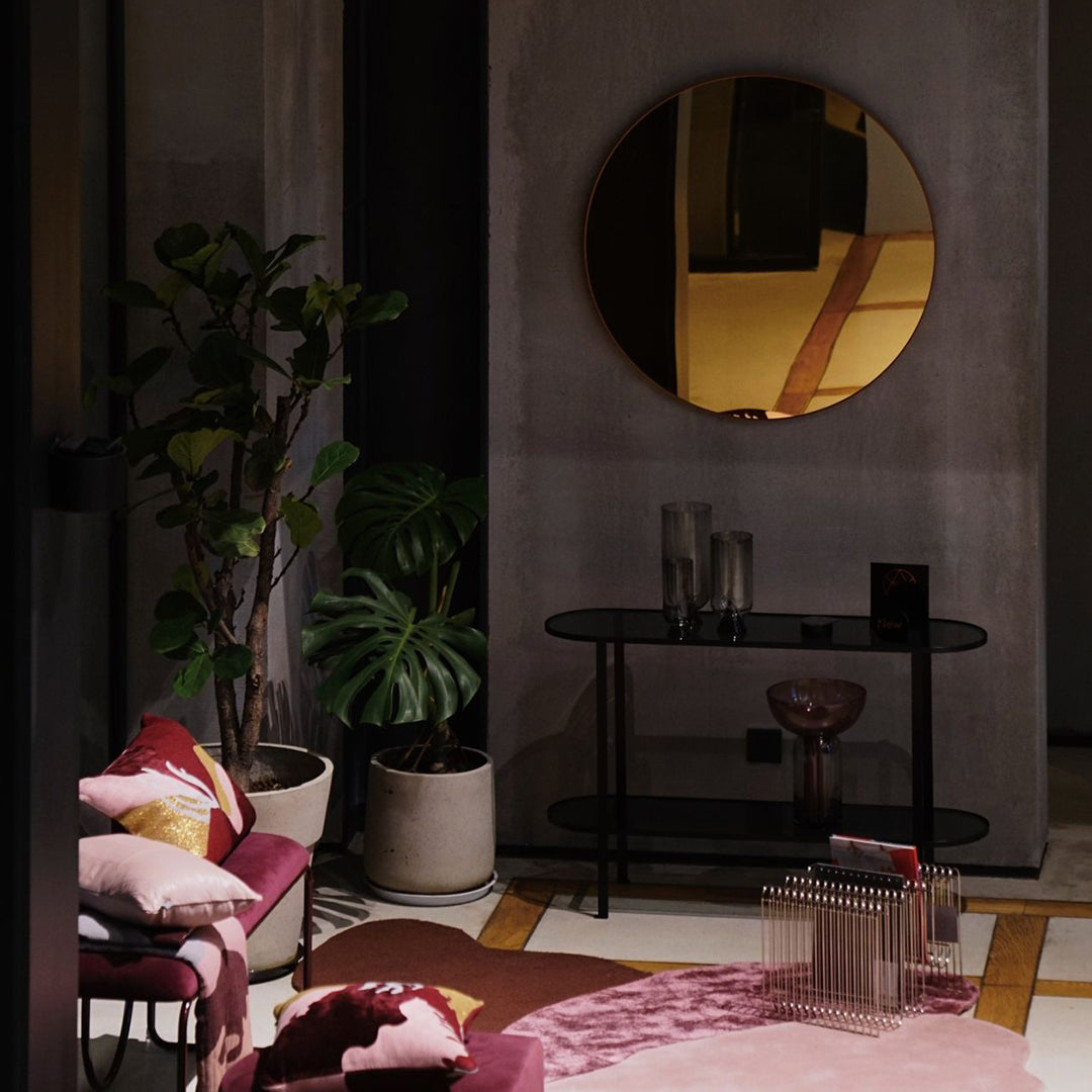 Cozy seating in deep pink and burgundy with soft floral patterns, paired with sleek black and gold accents.