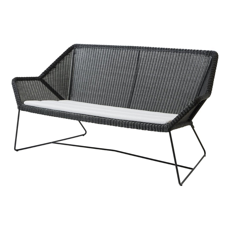 Black woven loveseat with a sleek modern design and contrasting white cushion. Ideal for stylish outdoor spaces.