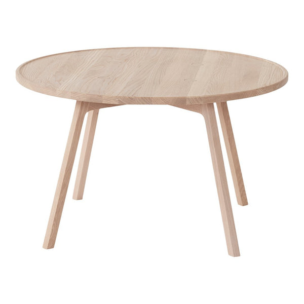 Light oak round coffee table with a smooth finish and natural wood grain pattern, perfect for modern decor.