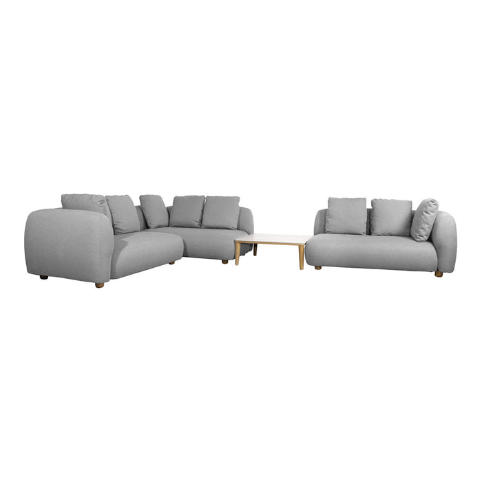 Light gray modular sofa set with soft fabric and minimalist design, featuring plush cushions and wooden legs.