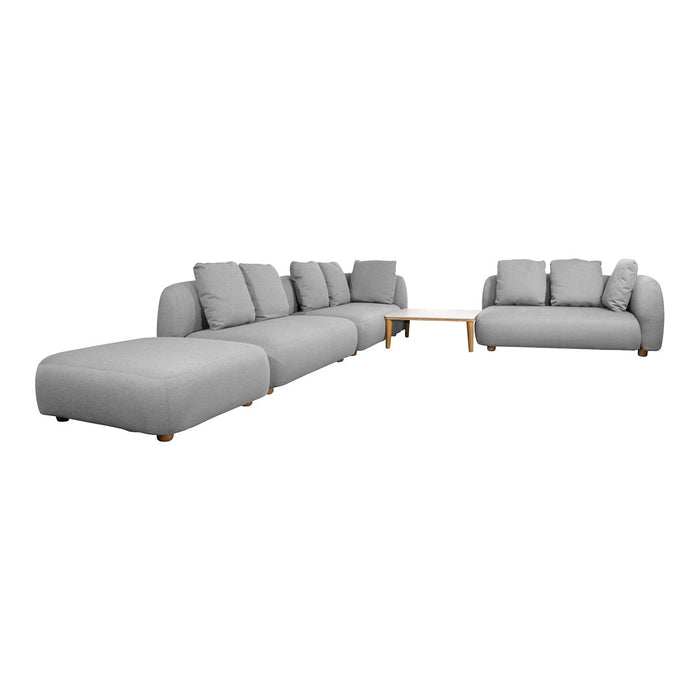 Modular sectional sofa in soft gray fabric with clean lines and plush cushions, accentuated by light wooden legs.