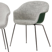 Gray textured fabric chair with a green underside and slender black metal legs. Modern design with soft curves.