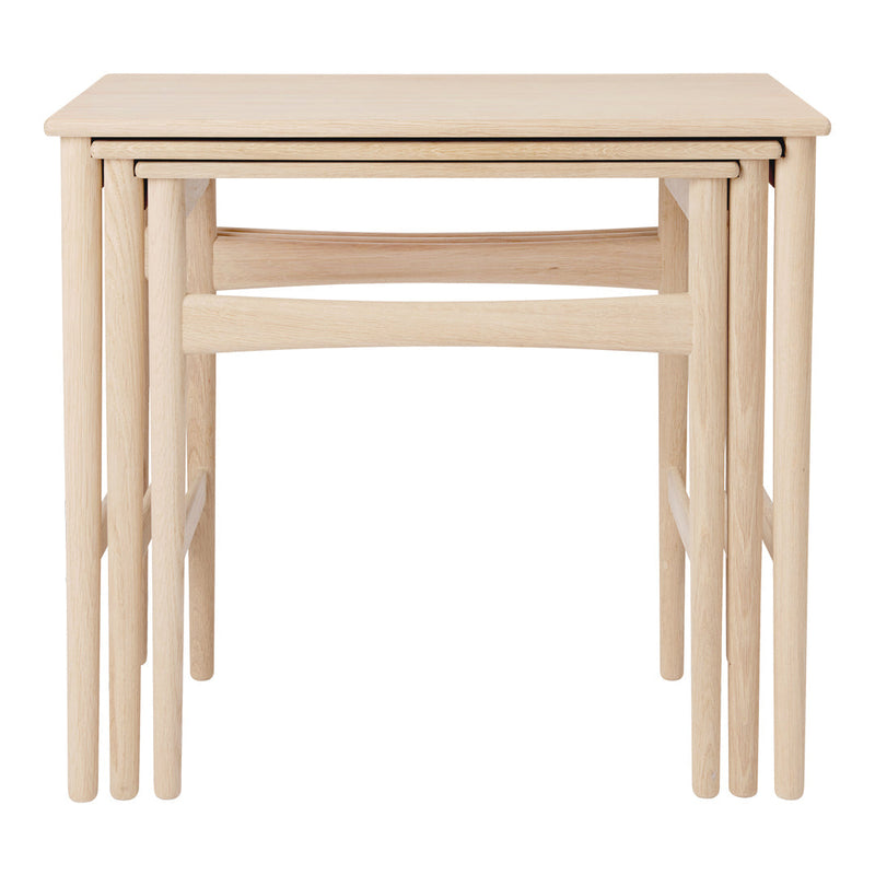 Light oak nested tables with a minimalist design, featuring smooth, natural wood grain and clean lines.
