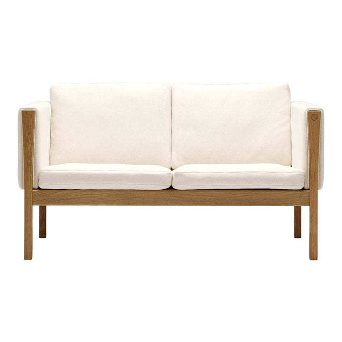 Cream upholstery sofa with wooden frame, featuring a clean, modern design and no visible patterns. Ideal for minimalist decor.