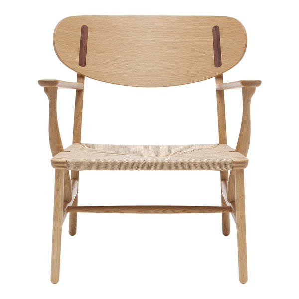 Wooden chair with a light oak finish, featuring a smooth grain and contrasting dark leather accents on the backrest.
