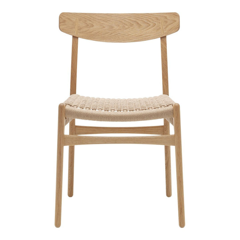 Light oak wood chair with a woven natural fiber seat and simple minimalist design.