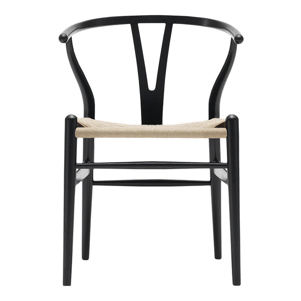 Black wooden chair with a Y-shaped back and woven straw seat, showcasing a minimalist and modern design.
