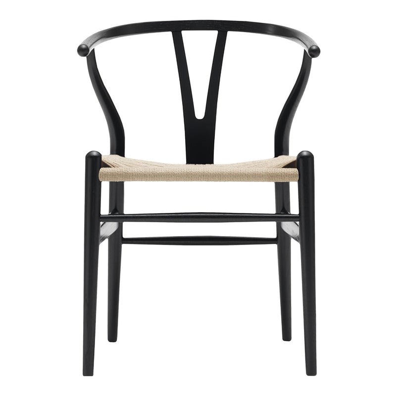 Black wooden chair with a Y-shaped back and woven straw seat, showcasing a minimalist and modern design.