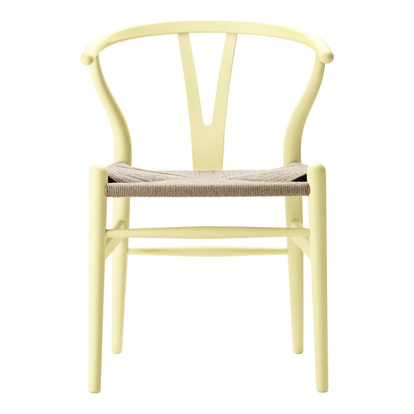 Light yellow wooden chair with a natural woven seat, showcasing a minimalist design and simple lines.