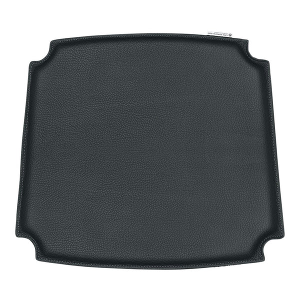 Black square grill mat with a smooth textured surface and rounded corners, perfect for cooking and grilling.