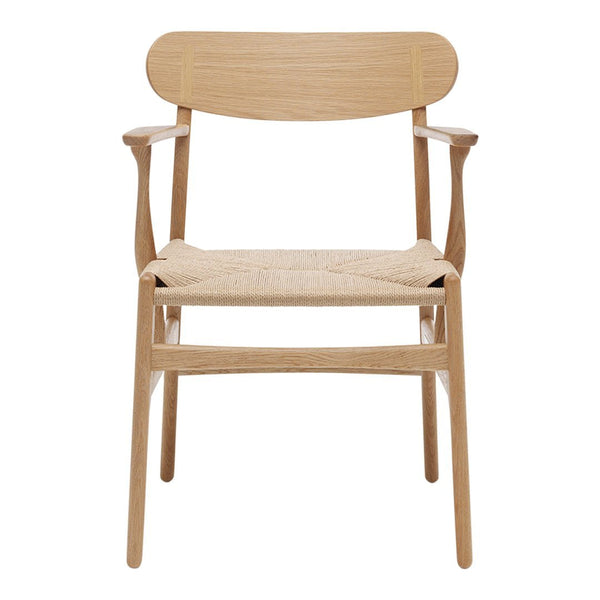 Natural wood armchair with a light finish and woven seat, showcasing minimalistic design and warm, earthy tones.