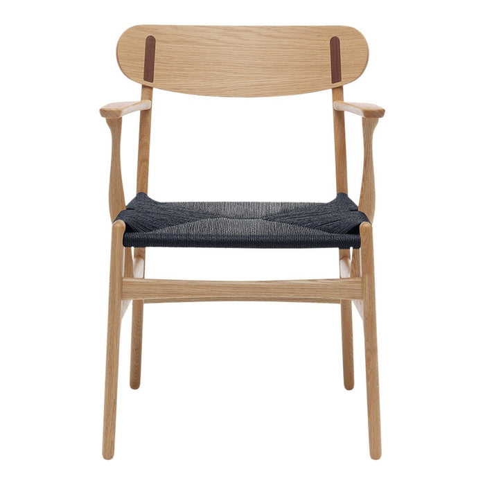 Light oak wooden chair with a dark blue seat and minimalist design, featuring natural wood grain and subtle leather accents.