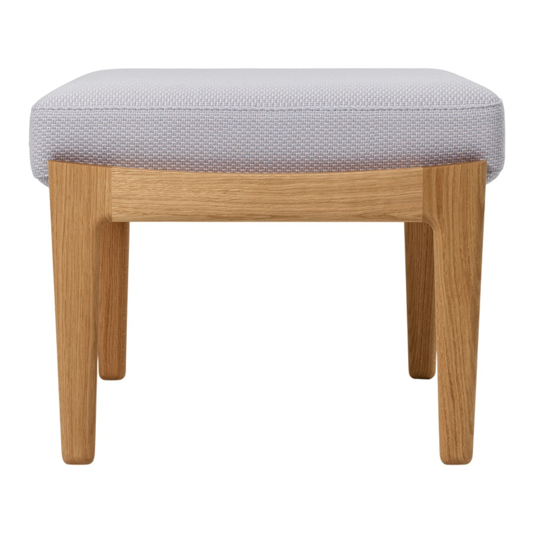 Gray patterned fabric ottoman with light wooden legs, offering a modern and stylish accent for any room.