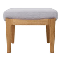 Gray patterned fabric ottoman with light wooden legs, offering a modern and stylish accent for any room.