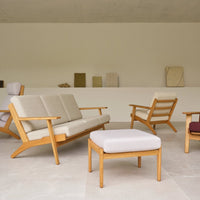 Beige and cream upholstered furniture with light wood accents, featuring a minimalist design and subtle geometric patterns.
