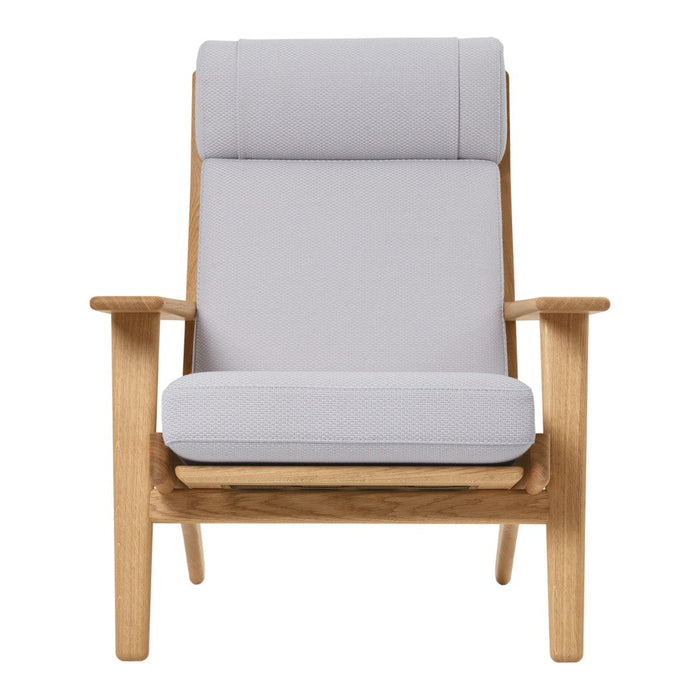 Light grey upholstered armchair with a smooth texture and natural wood frame, featuring a minimalist design.