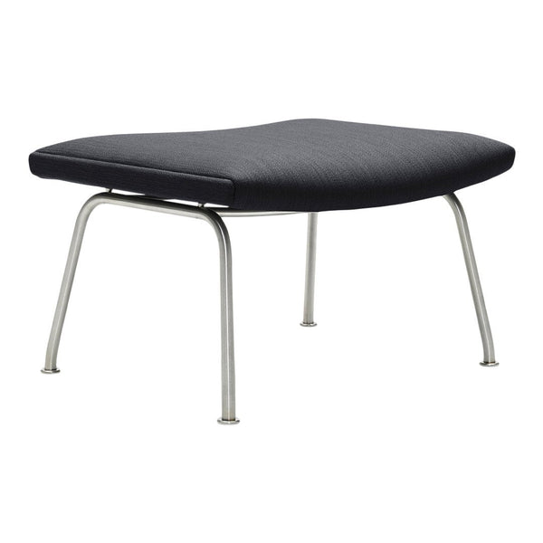 Black upholstered ottoman with a sleek design and silver metal legs. Modern minimalist style for any decor.