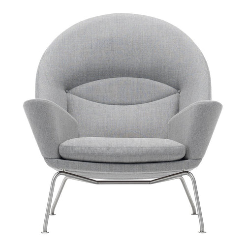 Gray upholstered chair with a modern, rounded design and sleek metal legs. Soft, smooth texture and minimalist aesthetic.