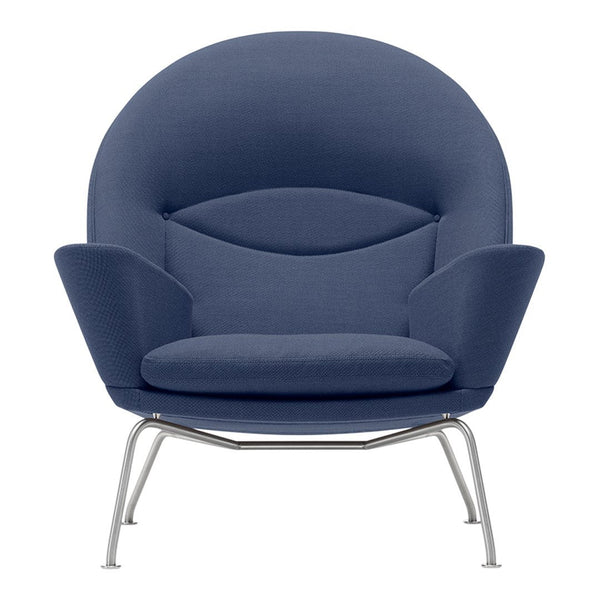 Blue fabric lounge chair with a smooth, rounded design and silver metal legs. Modern and stylish accent piece.