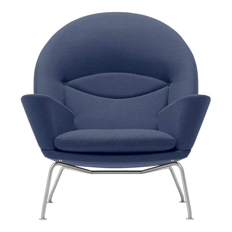 Blue fabric lounge chair with a smooth, rounded design and silver metal legs. Modern and stylish accent piece.