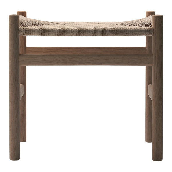 Natural wood stool with a light beige woven seat, showcasing a minimalist design and earthy tones.