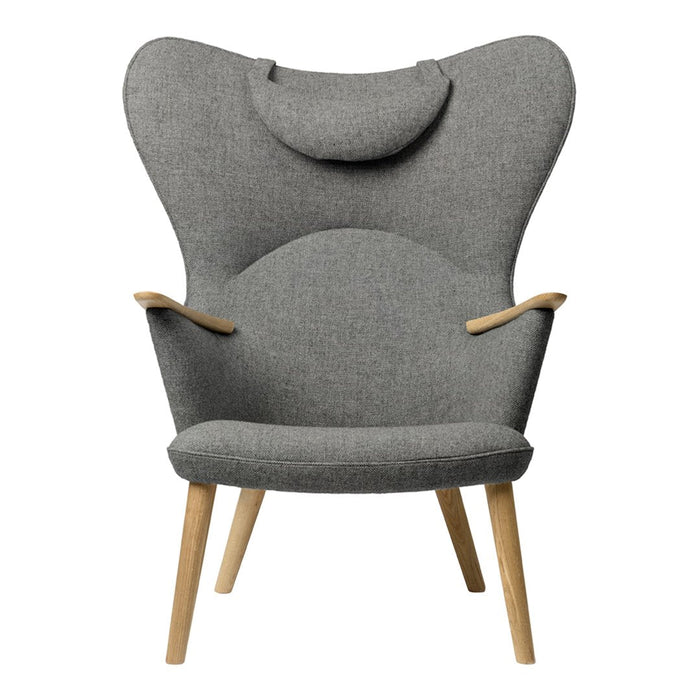 Grey upholstered chair with a unique winged design and natural wood legs, showcasing a modern, minimalist aesthetic.