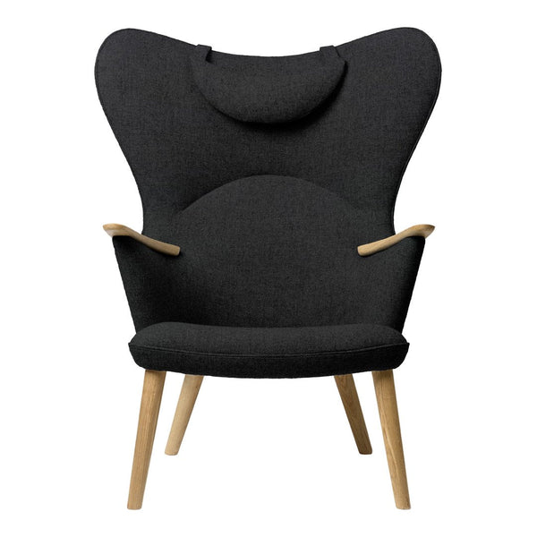 "Stylish black upholstered chair with a unique butterfly shape and wooden legs, perfect for modern decor."