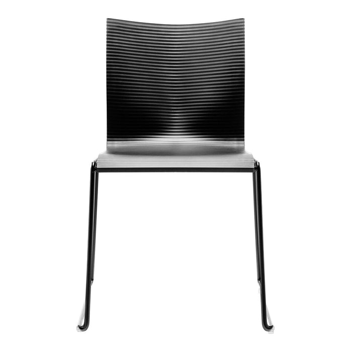 Black, textured stripe pattern chair with a white seat and sleek black legs. Modern design for contemporary spaces.
