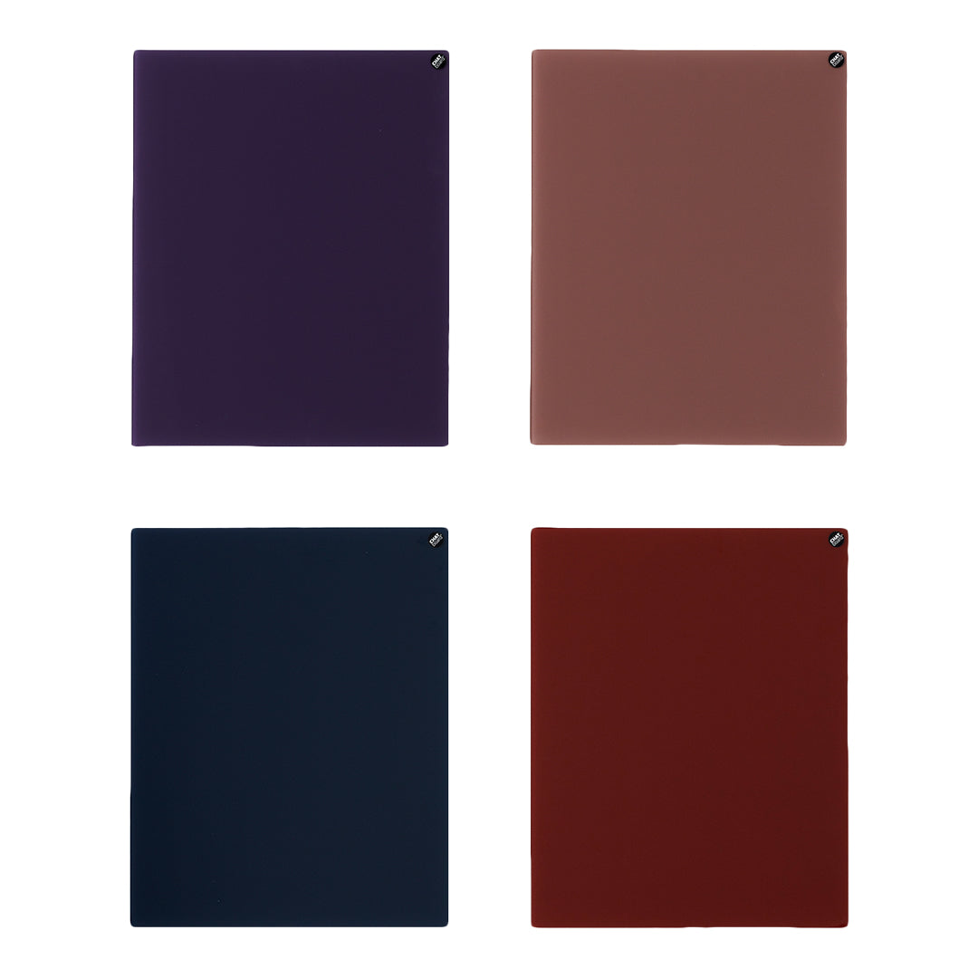 "Set of four notebooks in dark purple, rust, navy blue, and deep red with solid color finishes."