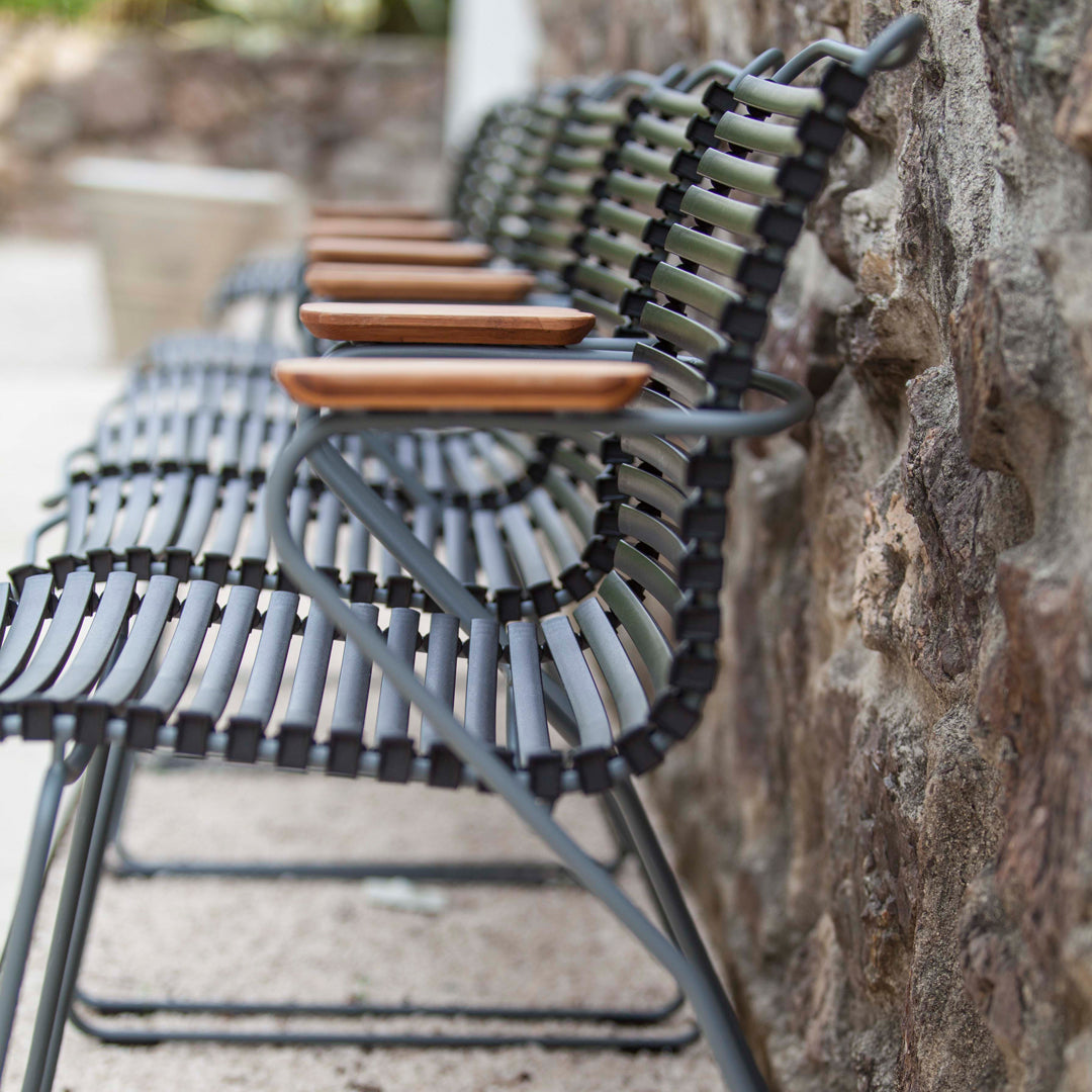 Black and gray woven chair with wooden armrests, showcasing a modern, minimalist design.