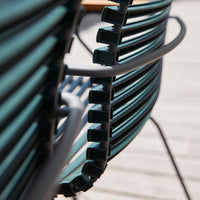 Black and green striped chair with sleek lines and modern design, perfect for outdoor or indoor settings.