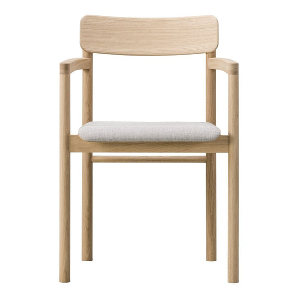 Light wood chair with a smooth finish and a soft, light gray upholstered seat. Minimalist, contemporary design.