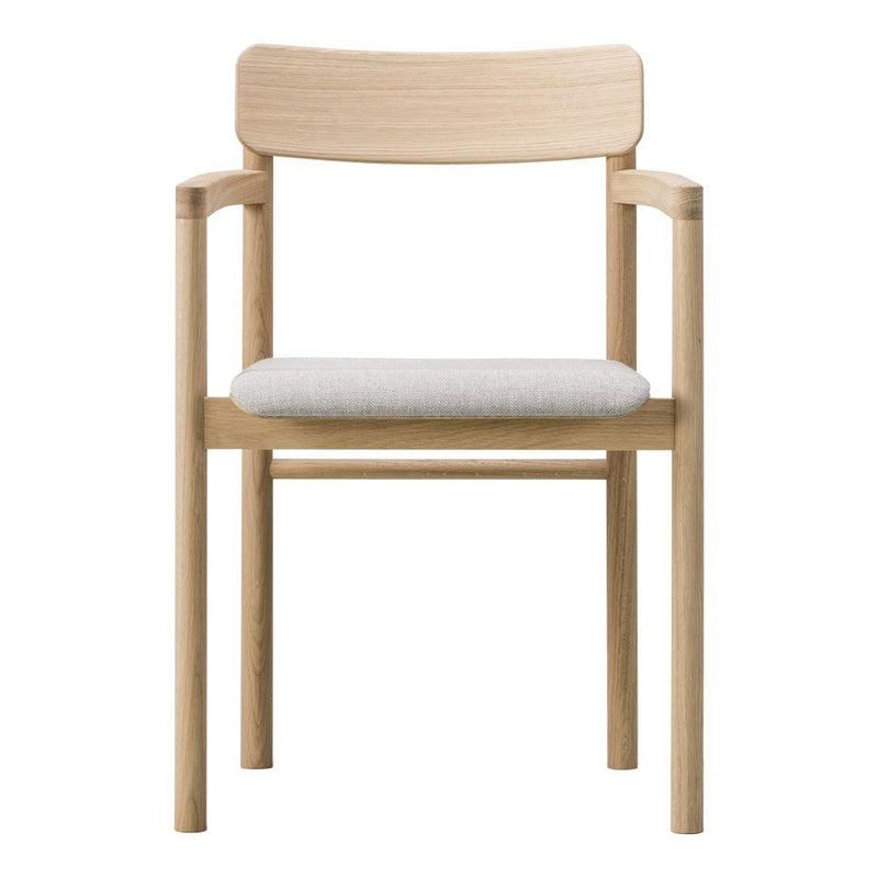 Light wood chair with a smooth finish and a soft, light gray upholstered seat. Minimalist, contemporary design.